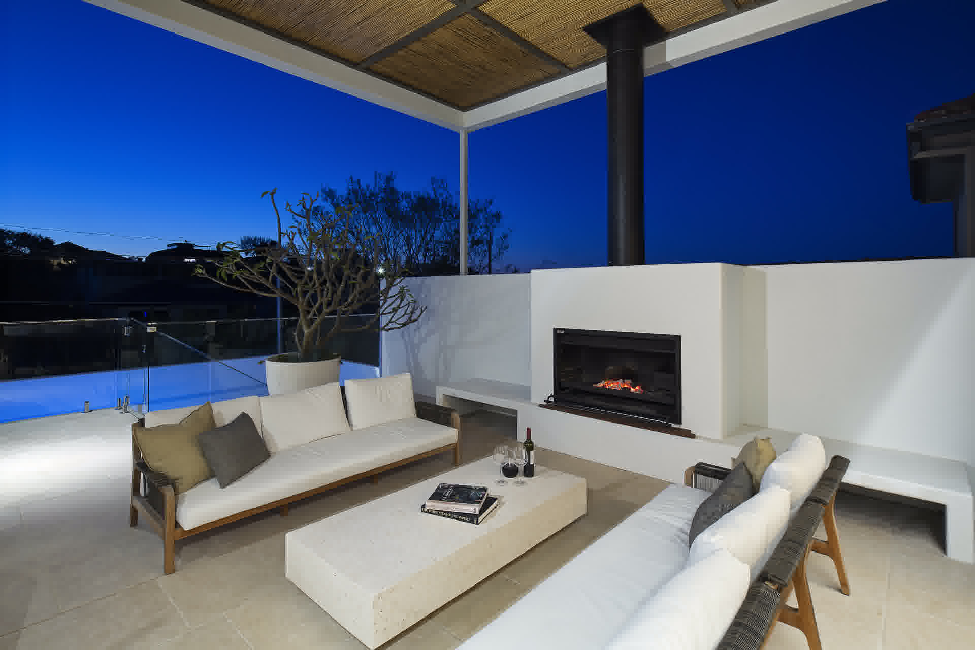 Nighttime loggia with outdoor fireplace