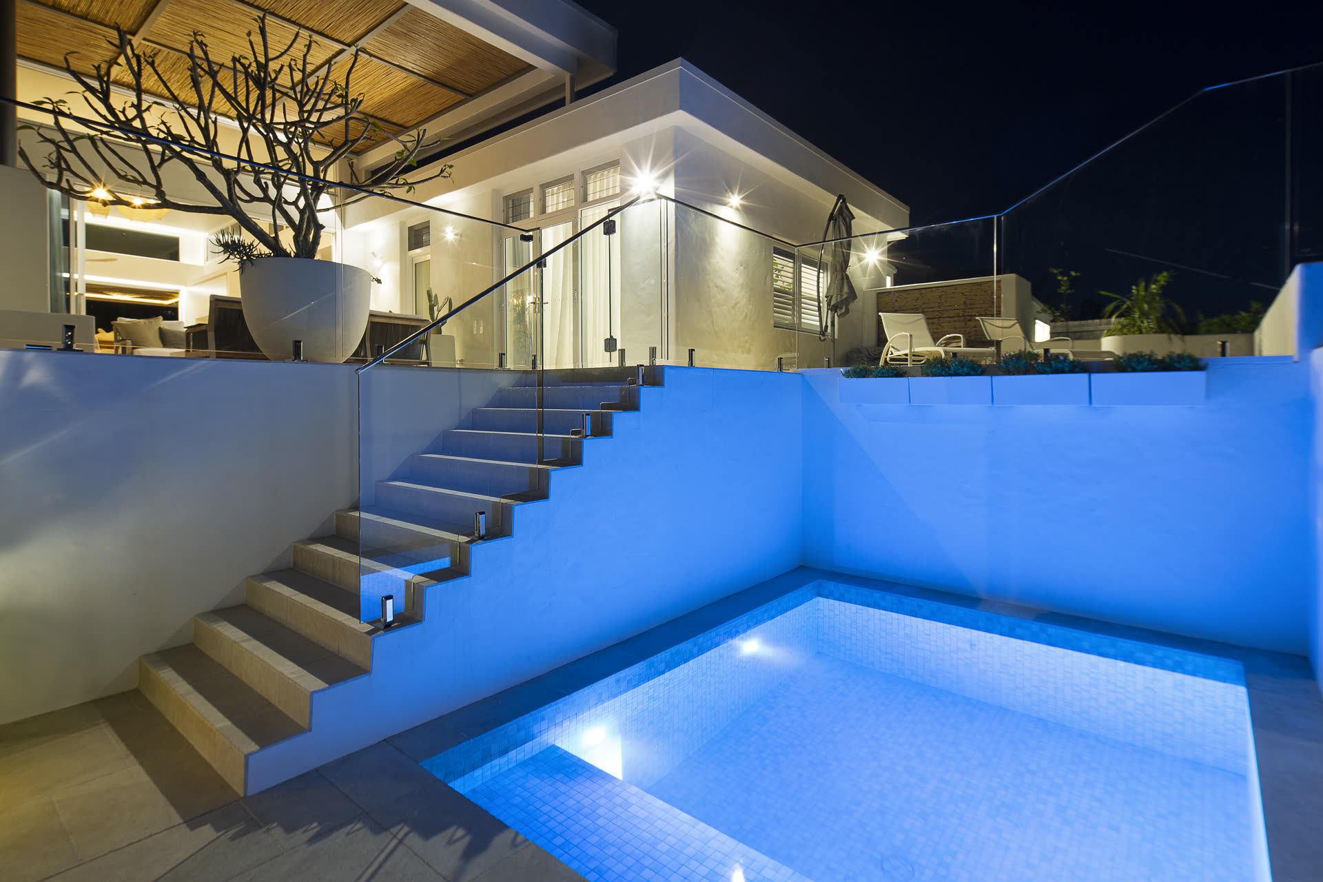 Pool at dusk with feature lighting